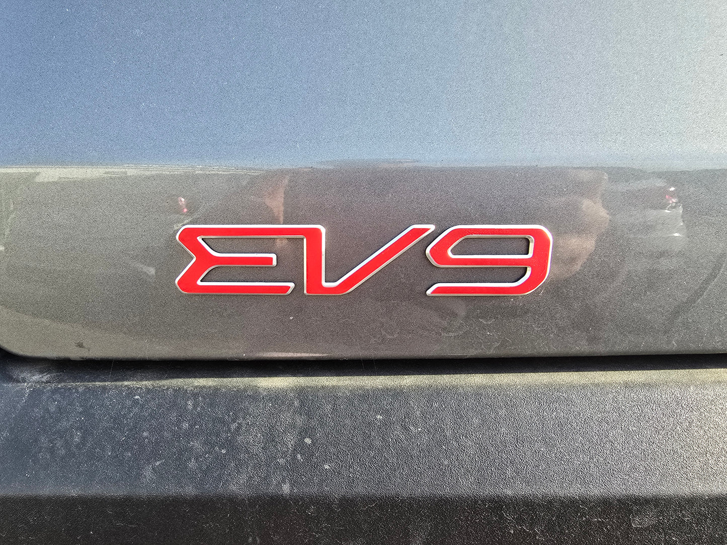 Red 'EV9' overlay on a black background