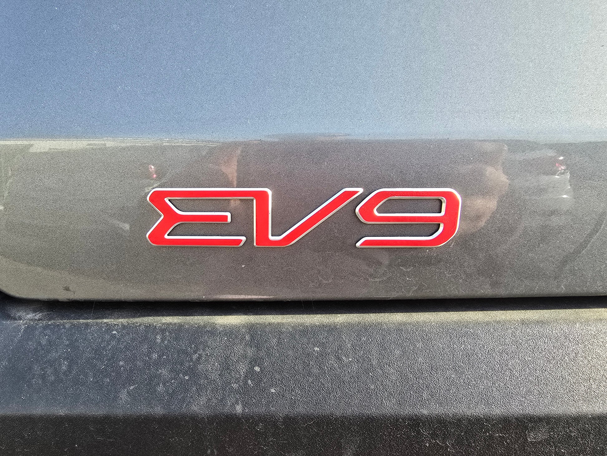 Red 'EV9' overlay on a black background