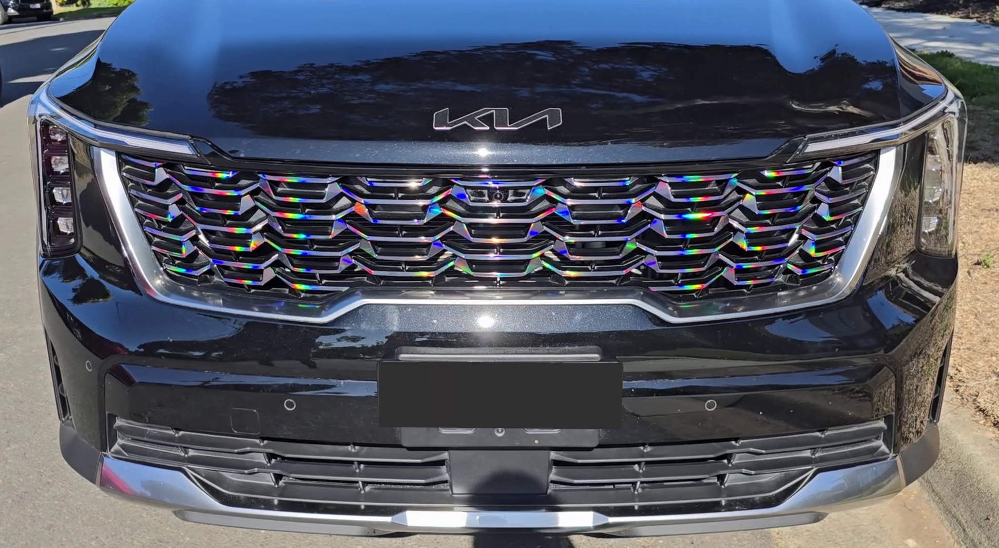 Front view of a Kia Sorento with a rainbow-colored grille.