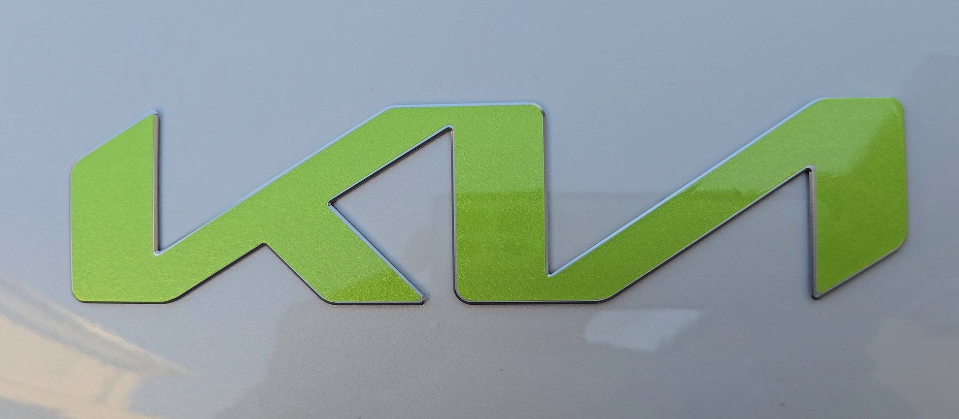 Green KIA emblem overlay on a white background